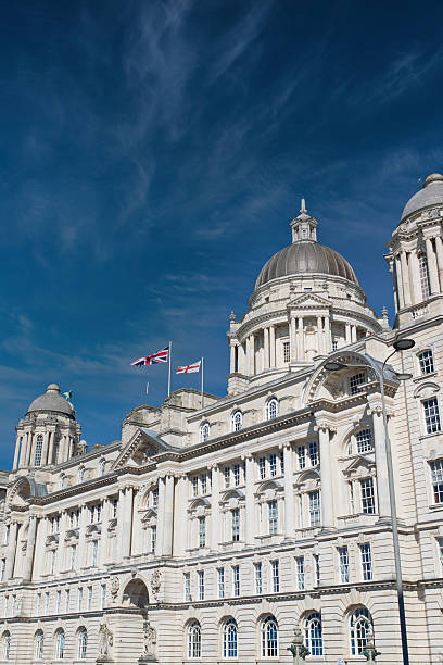 istock White Building with Domes and Flags Against Blue Sky in Liverpool, UK. 2214485510