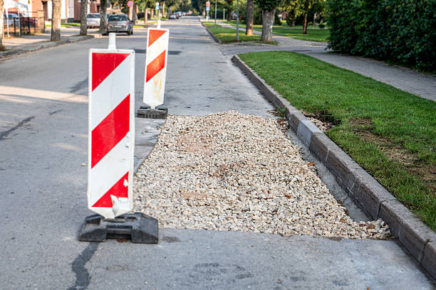 istock Road repair, piled stone chips before laying asphalt 2214486740
