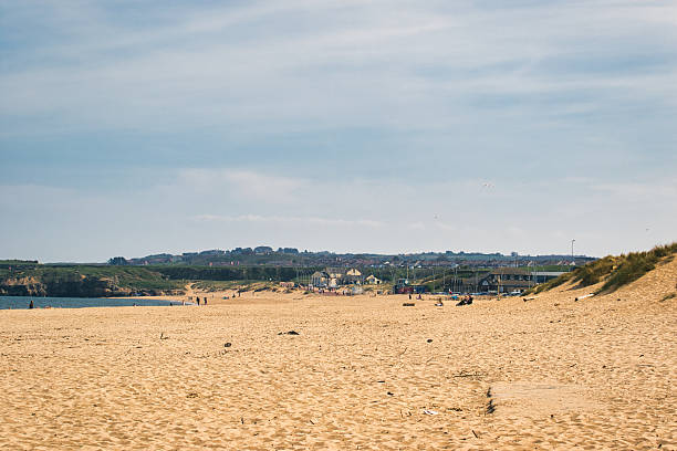 istock Sandy Beach with Distant Buildings and People at Sandhaven Beach, UK 2214487956