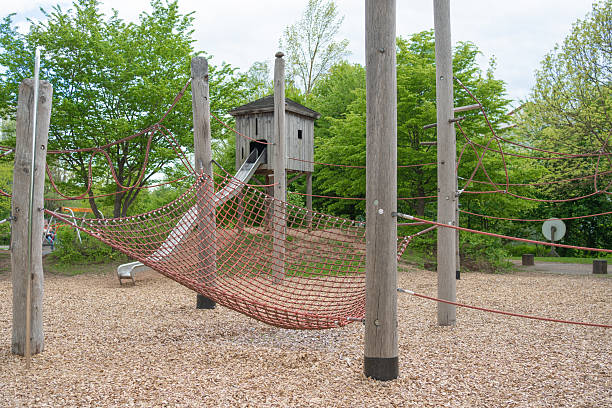 istock Wooden Playground with Slide and Climbing Net Structure 2214488408