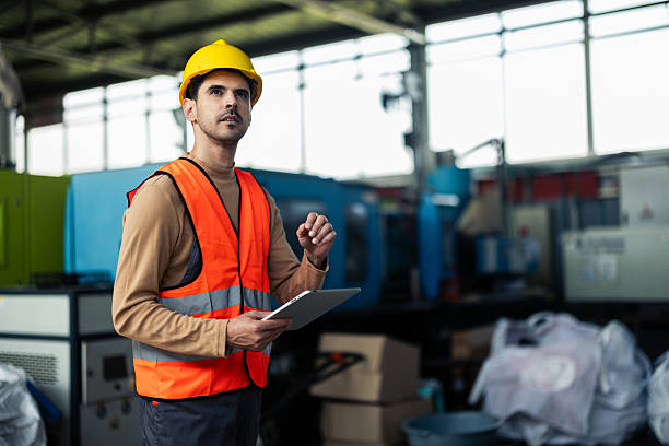 istock Industrial manager inspecting the manufacturing process via tablet 2214490777