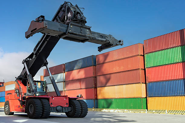 istock Aerial view of crane lifting up container in yard 2214491431