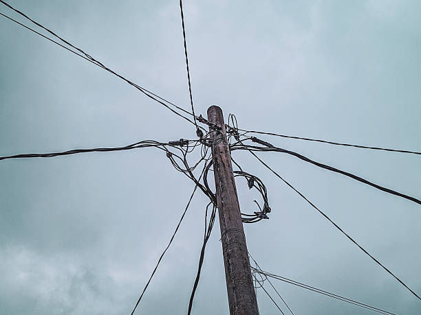 one electric pole with many cables against the sky background