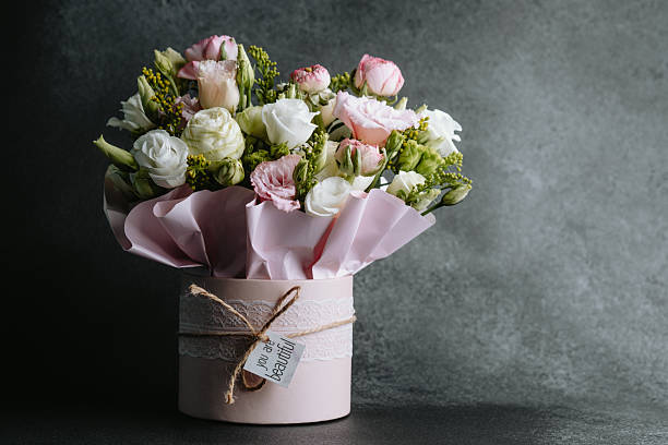 Vibrant floral arrangement in pastel-colored container for special occasions