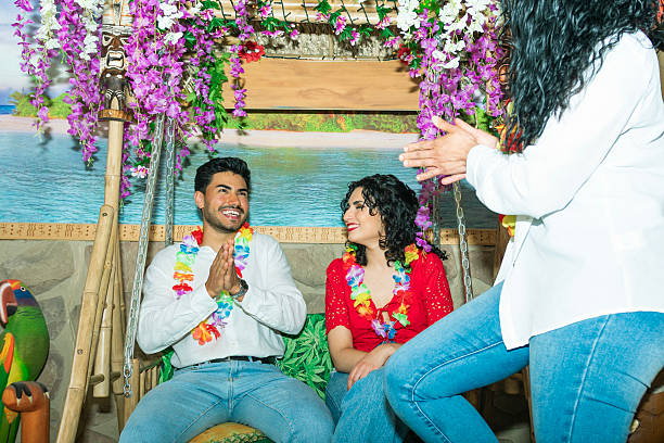 istock Friends enjoying tropical themed party, clapping and smiling 2214494701