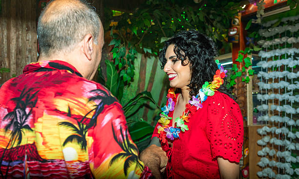 istock Guests shaking hands at tropical themed party 2214494716