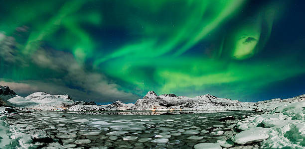 istock Aurora borealis over frozen lake - panorama 2214495942