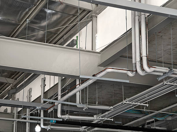 istock The ceiling of a large building under construction an extensive network of pipes 2214497302