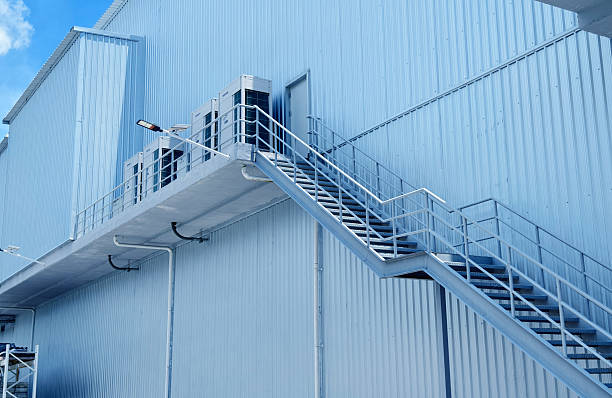 istock A set of stairs ascending a large blue wall 2214497679
