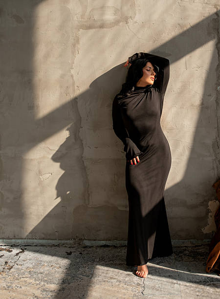 istock Silhouette of a brunette in diagonal sunlight on a wall 2214498038