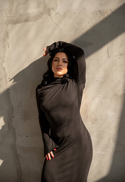 istock Brunette model leaning against a concrete wall 2214498095
