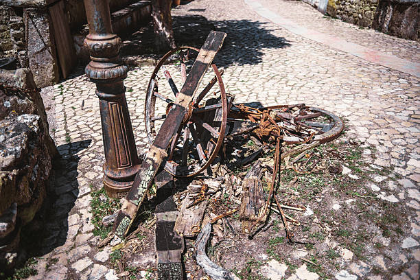 Old rusty metal agricultural equipment, abandoned and overgrown by nature. At the junkyard at a rural location. Historic and antique, vintage materials in the Netherlands. Tractor