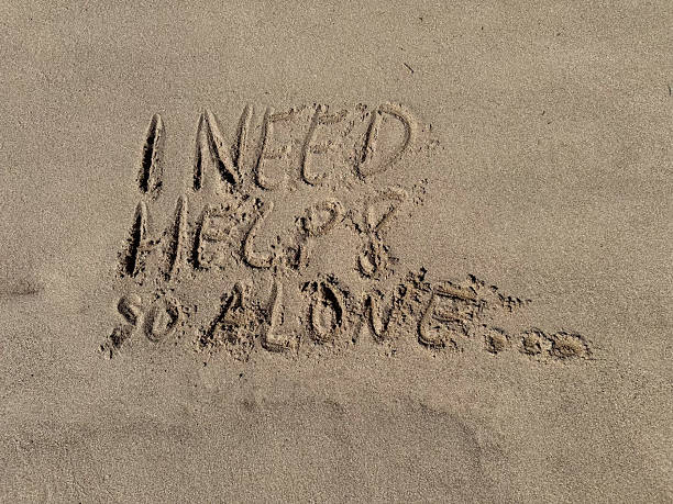 istock in a sand  beach the words i need help so alone are written 2214501280