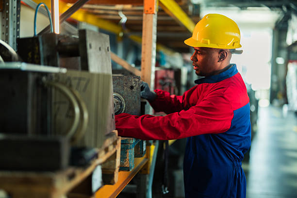 istock Worker at the factory operating on the manufacturing machines 2214502447