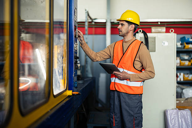istock Worker on the factory floor reviewing work procedures on a tablet 2214502492