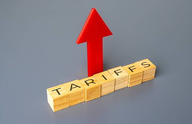 istock Upward pointing arrow and wooden blocks with word TARIFFS. 2214503124