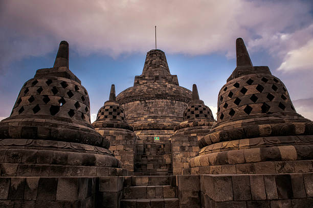 Borobudur Temple, located in Central Java, Indonesia, is the largest Buddhist temple in the world, built in the 8th and 9th centuries during the Syailendra Dynasty. Designed as a massive stone mandala, it symbolizes the journey to enlightenment, with nine stacked platforms featuring over 2,600 relief panels and 500 Buddha statues. The temple was abandoned for centuries before undergoing significant restoration in the 20th century, with UNESCO's support. A UNESCO World Heritage Site, Borobudur is both a religious pilgrimage site and a major tourist attraction, celebrated for its architectural brilliance and cultural significance, especially during Buddhist festivals like Vesak.