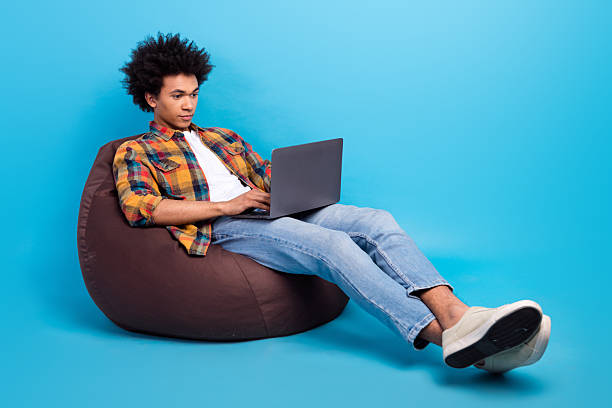 istock Full length photo of cheerful funky guy dressed checkered shirt working modern device empty space isolated blue color background 2214507101