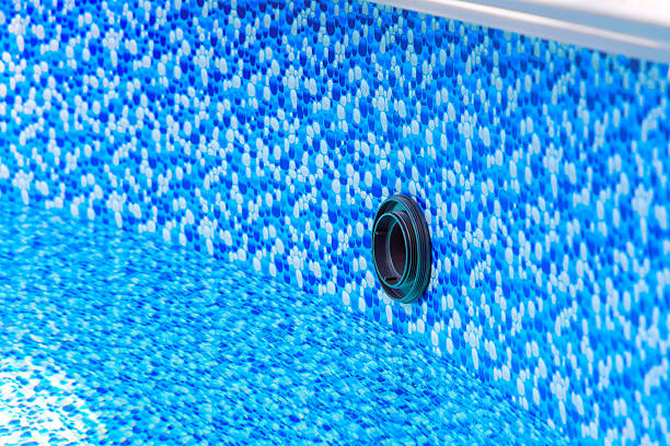 istock Close up view of blue mosaic pool liner with drainage opening visible during 2214507154