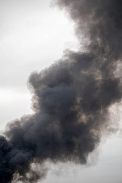 Dark black smoke rising into the sky.