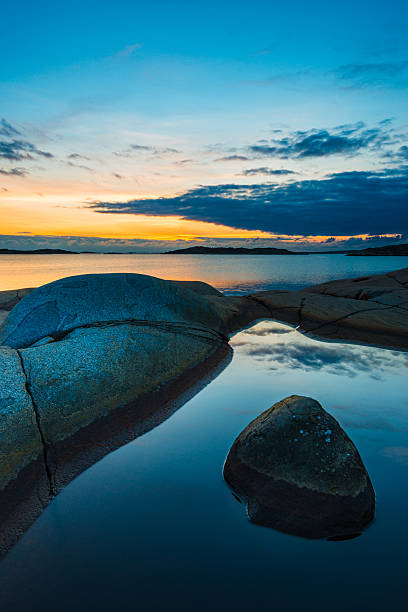 istock Coastal sunset outside Gothenburg highlights rock formations and tranquil waters reflecting the sky 2214512514