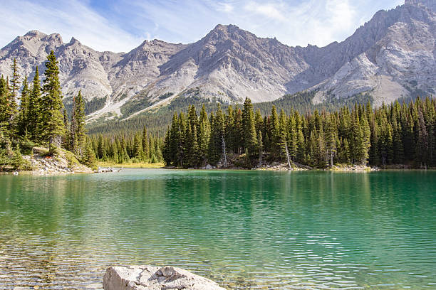 istock Rocky Mountains with clear teal water in the foreground 2214512740
