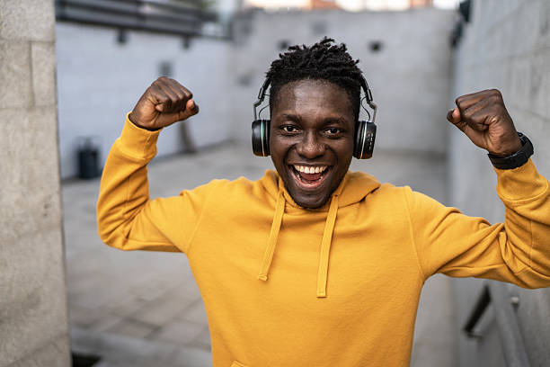 istock Young man listening to music and feeling powerful 2214514085