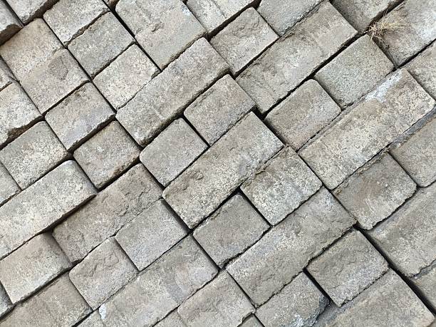 istock Textured grey concrete bricks stacked in a tight, weathered arrangement. 2214517138