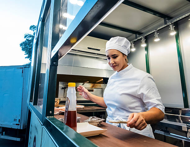 istock Female Chef Preparing Pizza Inside Food Truck Kitchen 2214520251