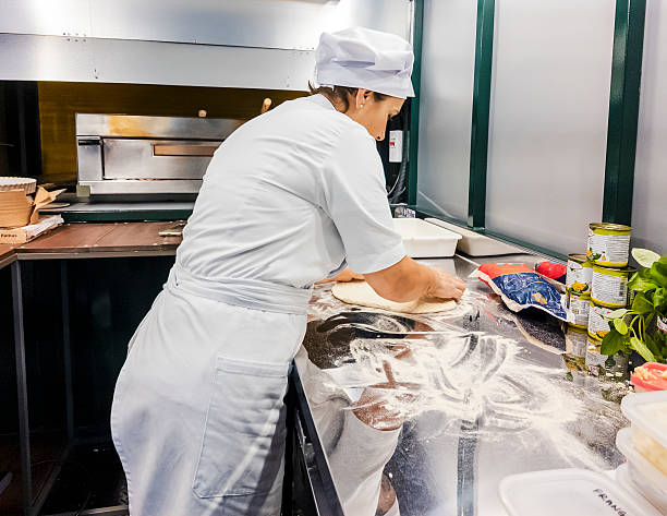 istock Female Chef Preparing Pizza Inside Food Truck Kitchen 2214520335