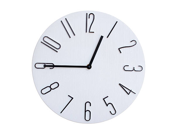 Simple round wall clock with black frame and white face, showing the time exactly at 00:45 or 12:45. Representing time precision in concepts of deadlines.