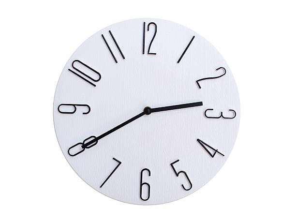 Minimalist Round Wall Clock Showing 02:40 or 14:40. Thin Black Numerals on White Wood Background.