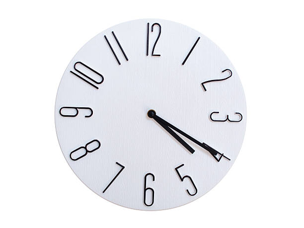 Minimalist Round Wall Clock Showing 04:20 or 16:20. Thin Black Numerals on White Wood Background.