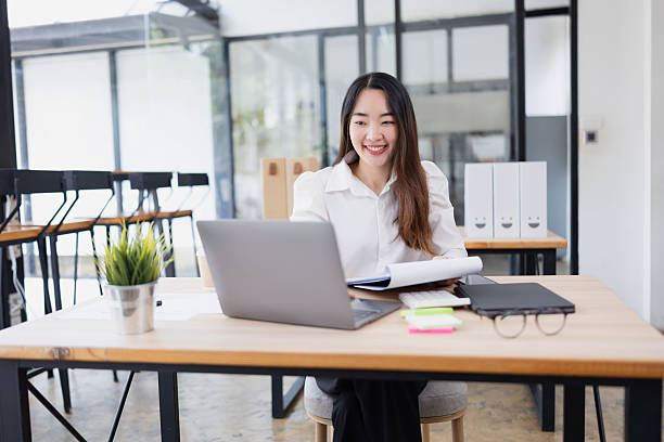istock Asian businesswoman analysis data at desk in office working space. 2214521572