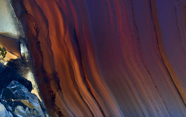 istock Amazing Banded Agate Crystal cross section cut isolated with reflection. Natural light translucent agate crystal surface, abstract structure slice mineral stone macro closeup 2214525901
