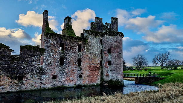istock Historic Caerlaverock Castle Surrounded by a Moat Under a Blue Sky 2214526383