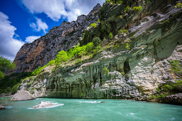 Water flowing down Verdon River in Les Gorges du Verdon in Provence France alongside beautiful hiking trail