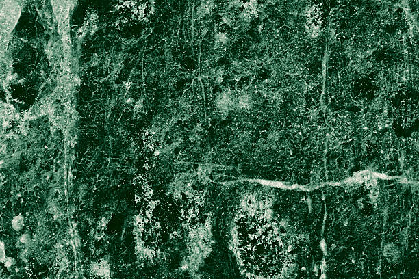 Real closeup of dark green marble stone texture surface background. Design pattern with high resolution for luxury home decoration. Abstract matt slab rock material. Front view of natural tiles stone surface.