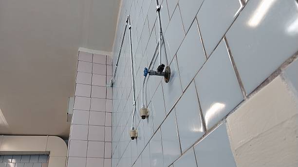 istock A bathroom with a shower head and a shower curtain rod. 2214528137