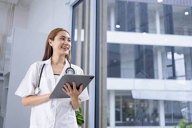 istock Female doctor using digital tablet standing in hospital. 2214530136