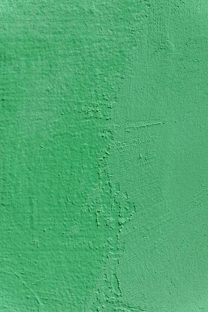 istock A wall with a green color and a rough texture. 2214532653