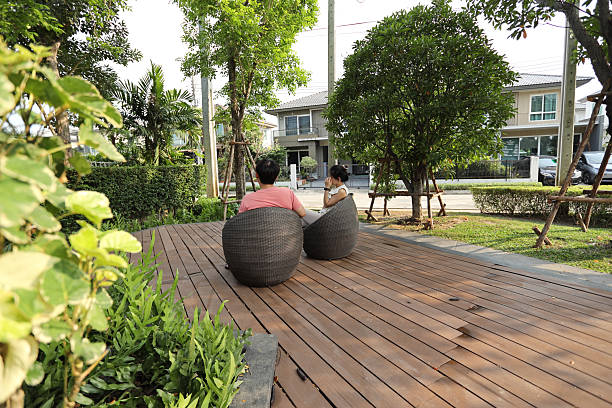 The East Asian couple is sitting and relaxing in the park.