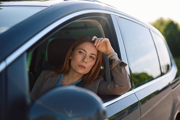 istock Pensive woman driving a car. 2214535168