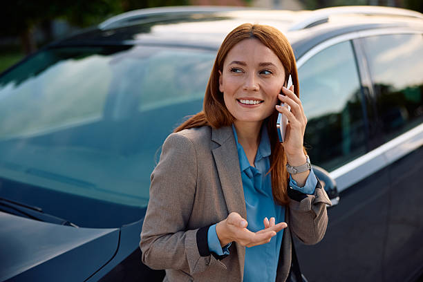 istock Happy woman talking on cell phone on parking lot. 2214535281
