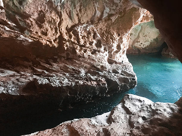 istock Cave with twisting stone formations and pools of clear turquoise water. 2214536617