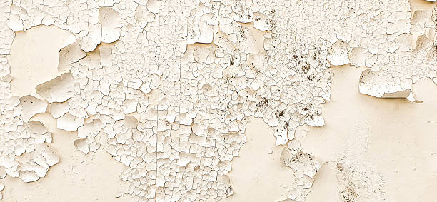 istock Distressed white textured wall with heavy peeling paint and rough texture background close-up 2214537054