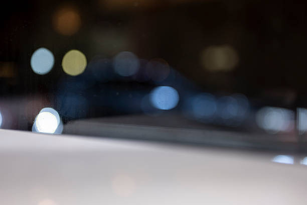 A blurred cityscape at night with bokeh effect highlighting colorful lights. The main scene is urban nightlife, creating a dreamy and atmospheric visual style. Potential usage includes backgrounds or artistic projects emphasizing ambiance.