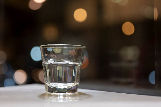 istock A Shot Glass on a Table with Bokeh Lights 2214541884