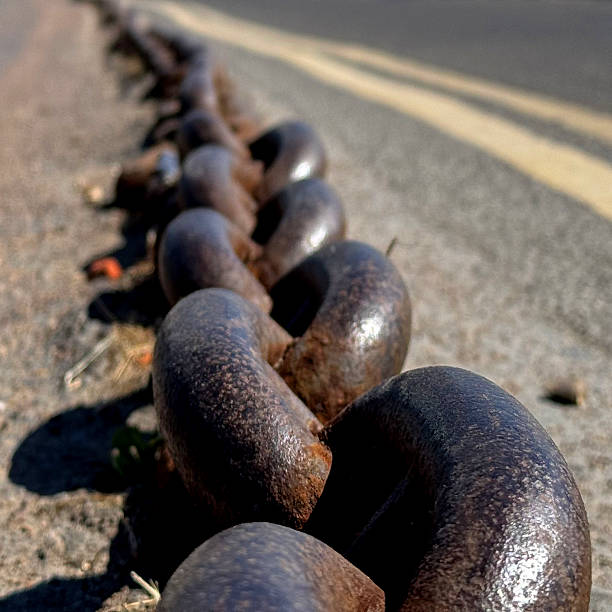 Old large chain on the ground in a car park in Mudeford, Hampshire