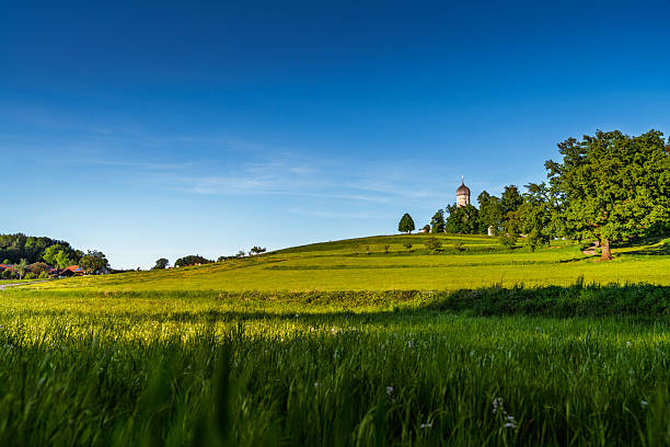 church in spring in bavaria with blue sky and green fields